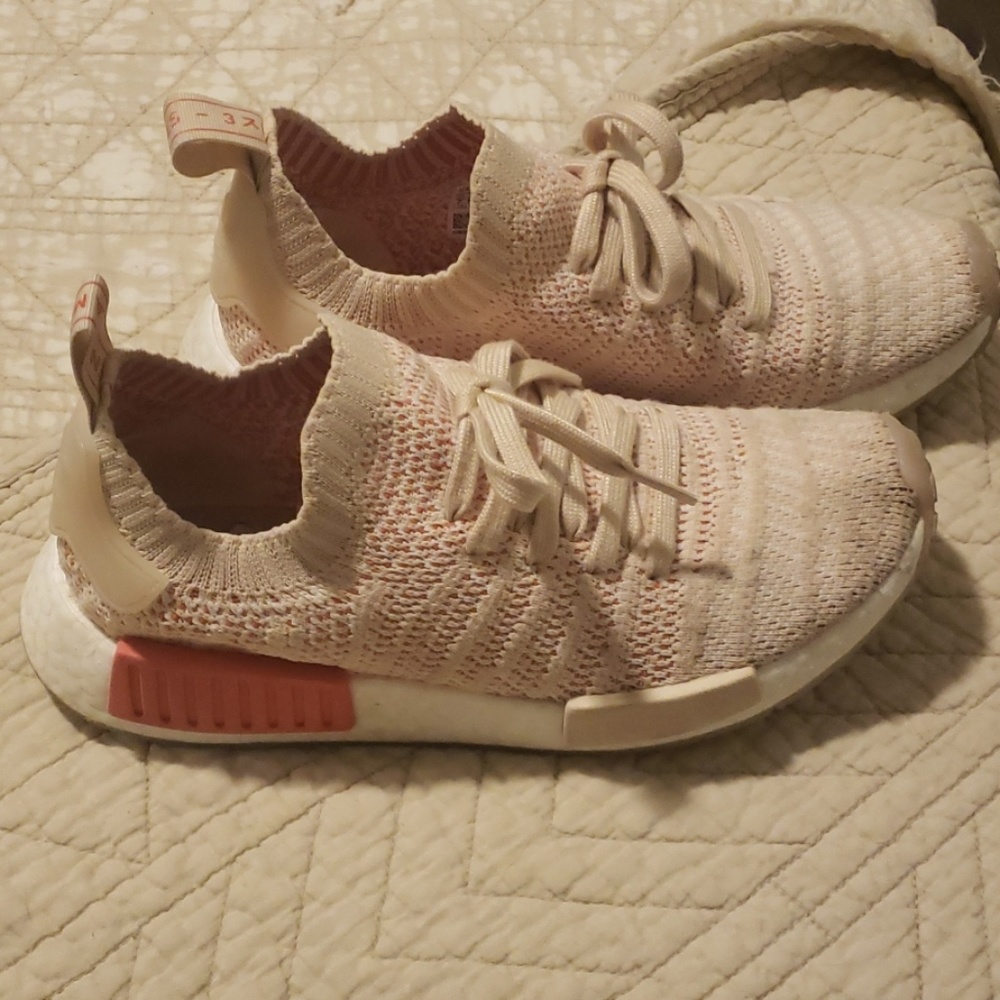 Adidas NMD coral and light beige shoes.